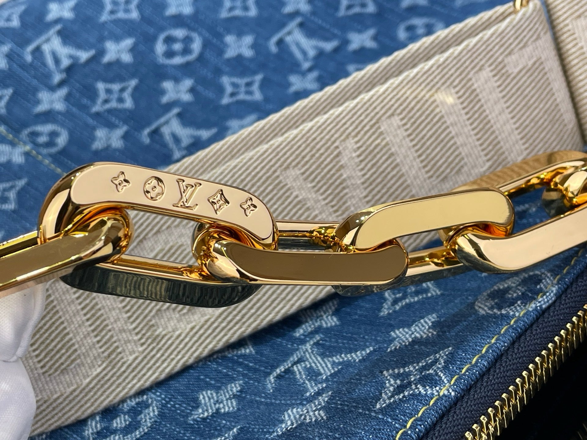 Louis Vuitton bag strap clasp and gold-tone hardware on blue monogram canvas