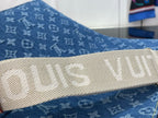Louis Vuitton tan strap with embossed lettering on blue monogram canvas