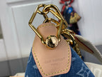 Louis Vuitton hobo bag handle close-up with gold-tone chain and tan leather patch
