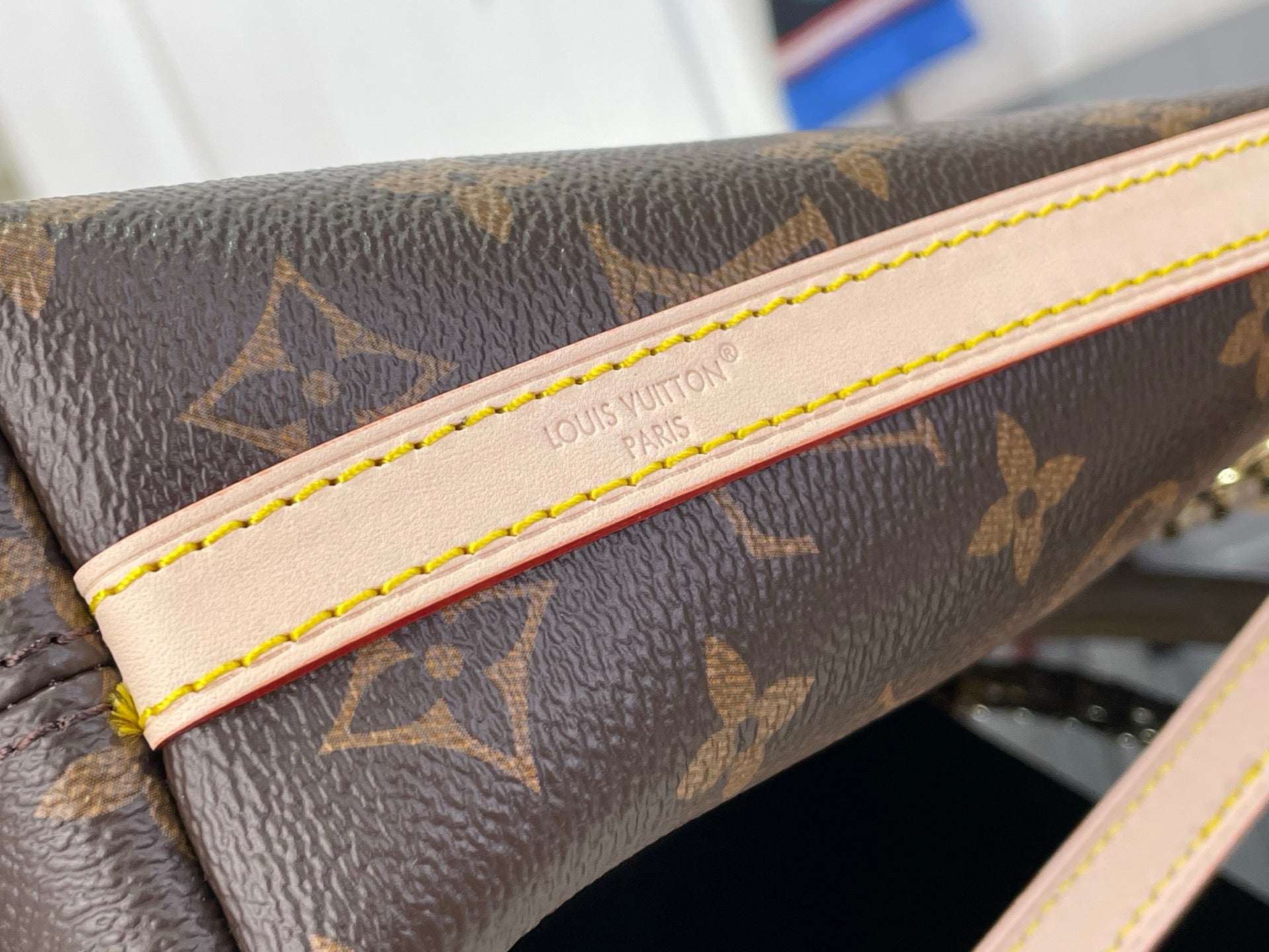 Louis Vuitton monogram bag leather edge trim with pale panel and yellow stitching