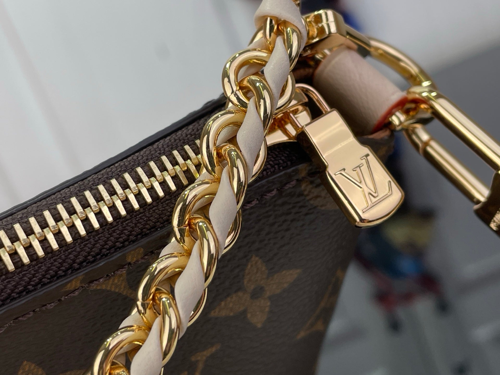 Louis Vuitton monogram bag zipper pull and gold chain with LV emblem