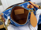 Louis Vuitton bag interior with tan leather label, blue monogram fabric, gold zipper trim