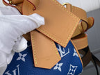 Louis Vuitton blue monogram bag with tan leather pocket flaps and stitching