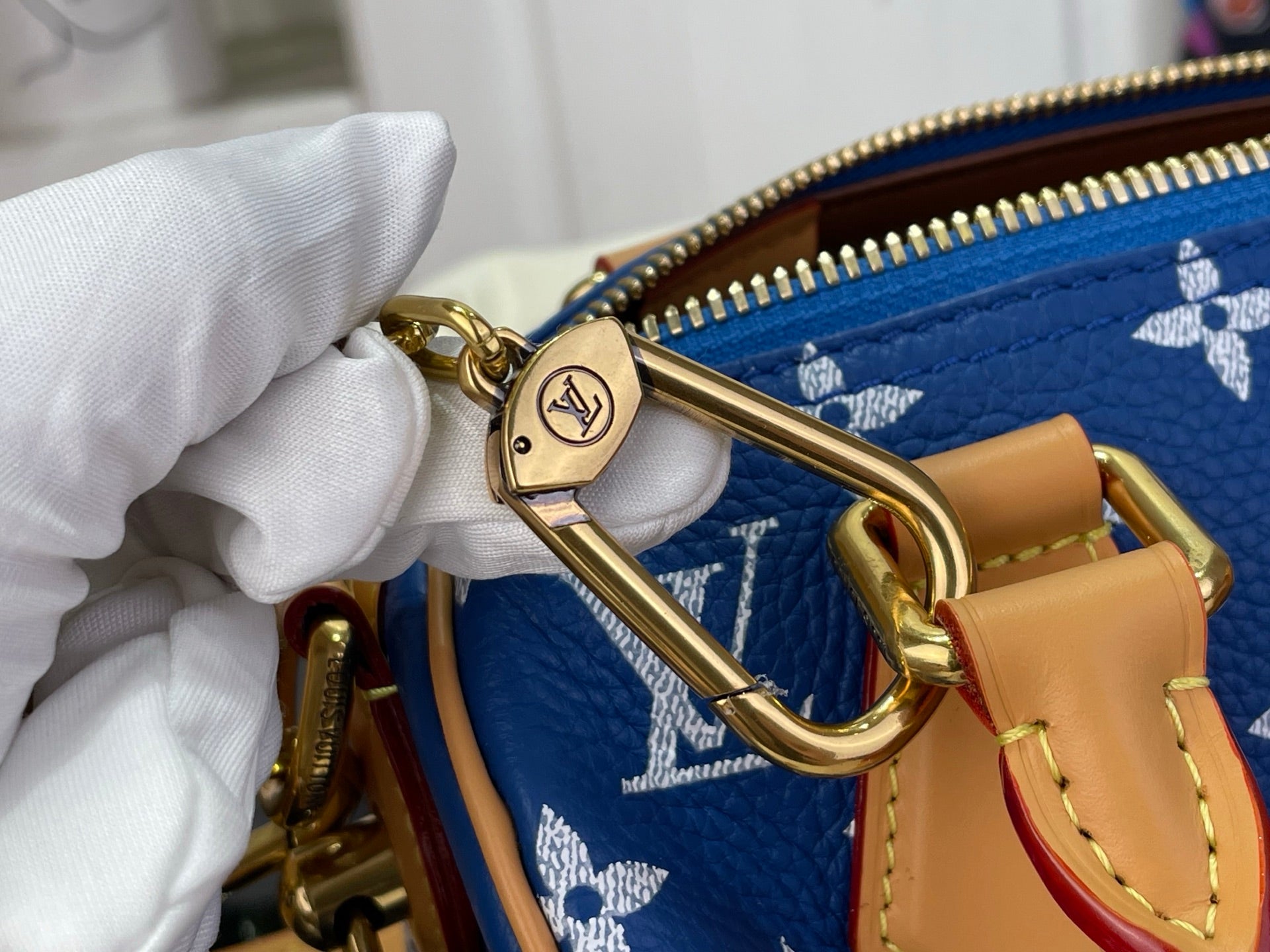Louis Vuitton bag gold clasp and D-ring on blue monogram fabric with zipper