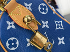Louis Vuitton blue monogram bag close-up of gold lock on tan leather strap