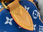 Louis Vuitton blue monogram bag close-up of tan leather tab with logo engraving