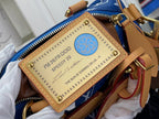 Louis Vuitton bag front patch with blue seal and gold-brown leather label, zipper edge