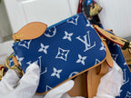 Louis Vuitton bag with blue monogram pattern and tan leather strap, small gold hardware