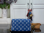 Louis Vuitton blue monogram bag with tan crossbody strap and hanging charm