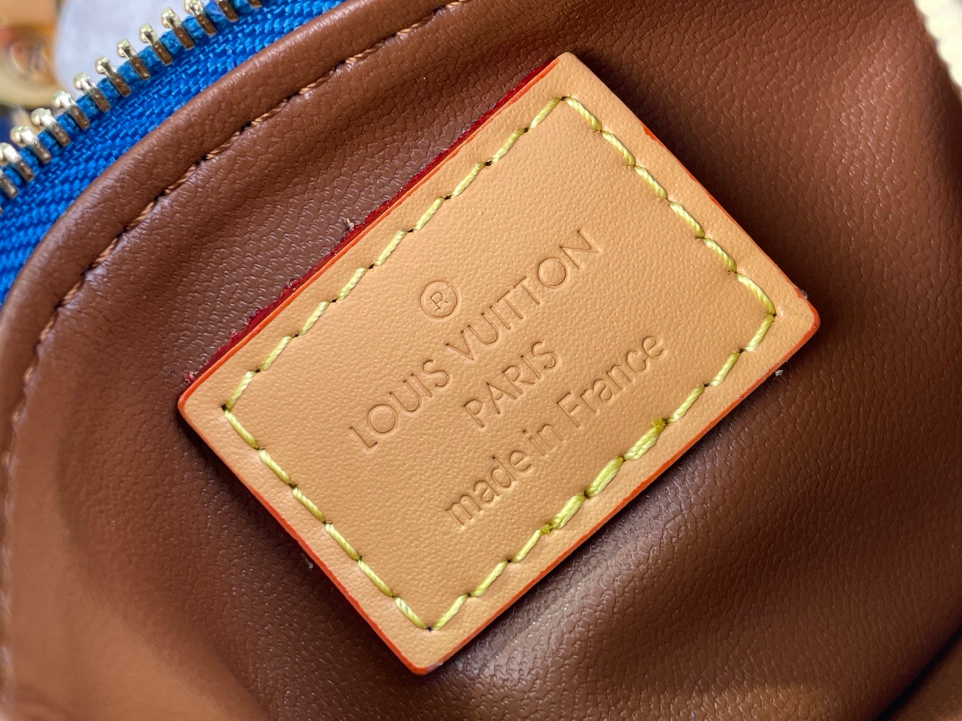 Louis Vuitton bag leather label reading Louis Vuitton Paris, made in France