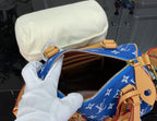 Louis Vuitton bag open top with tan leather lining and blue monogram fabric, interior view