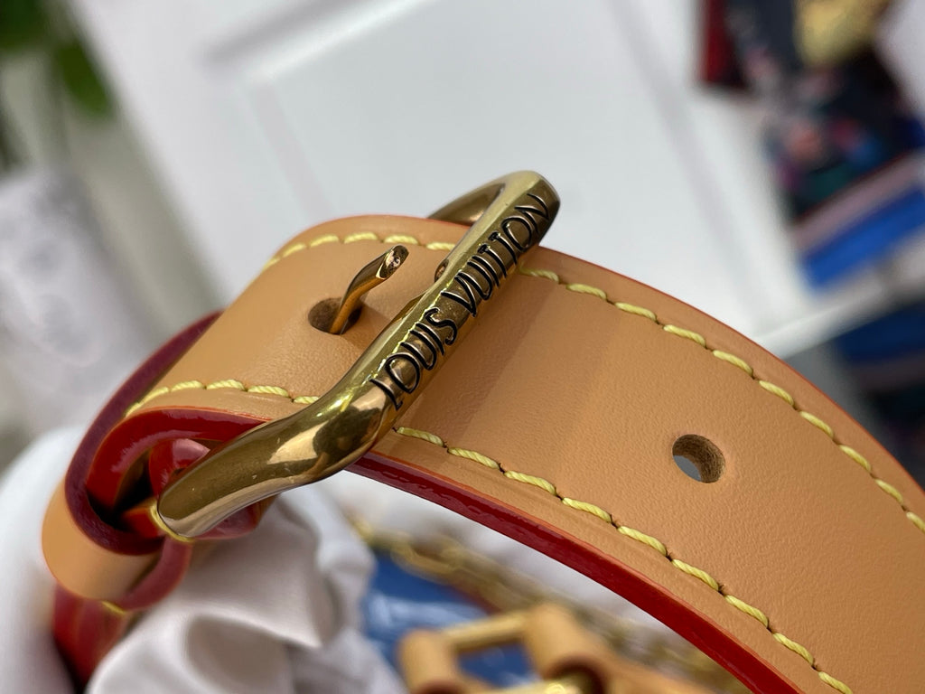 Louis Vuitton bag zipper pull with engraved Louis Vuitton, tan leather strap and red trim