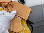 Designer handbag close-up: tan leather label with stitching and embossed text on flap