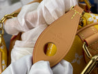 Designer handbag close-up: tan oval strap tab with embossed “LOUIS VUITTON PARIS”