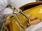 Louis Vuitton bag keyring hardware with gold-tone clip and zipper pull.