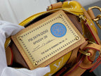 Louis Vuitton bag front logo patch with embossed text and blue circular seal.