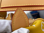 Louis Vuitton bag handle base in tan leather with stitched detail.