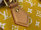 Designer handbag close-up of tan leather trim and round metal hardware on yellow monogram
