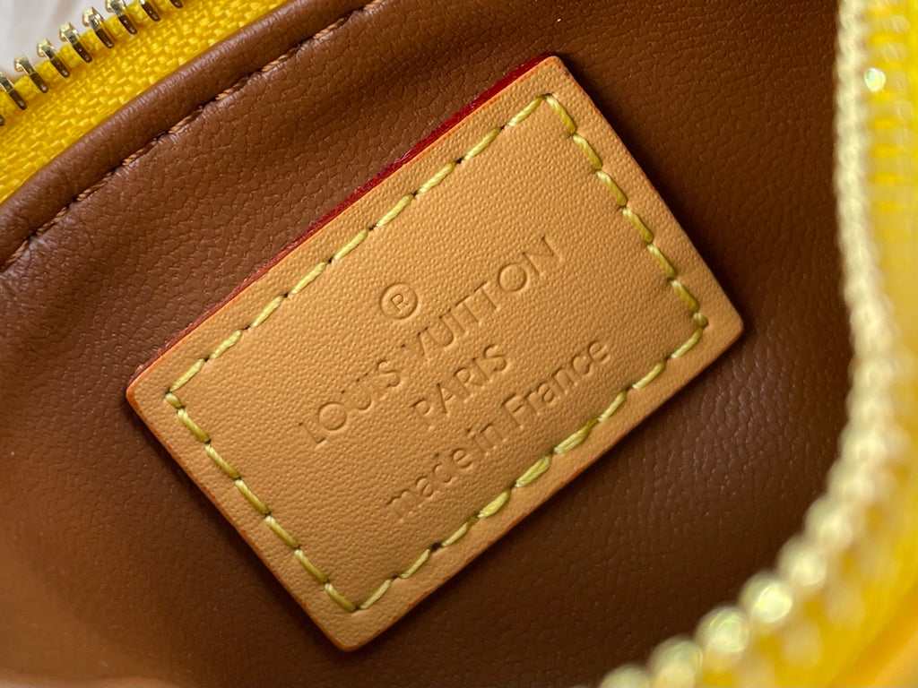 Louis Vuitton bag leather label reading "Louis Vuitton Paris" in embossed text.