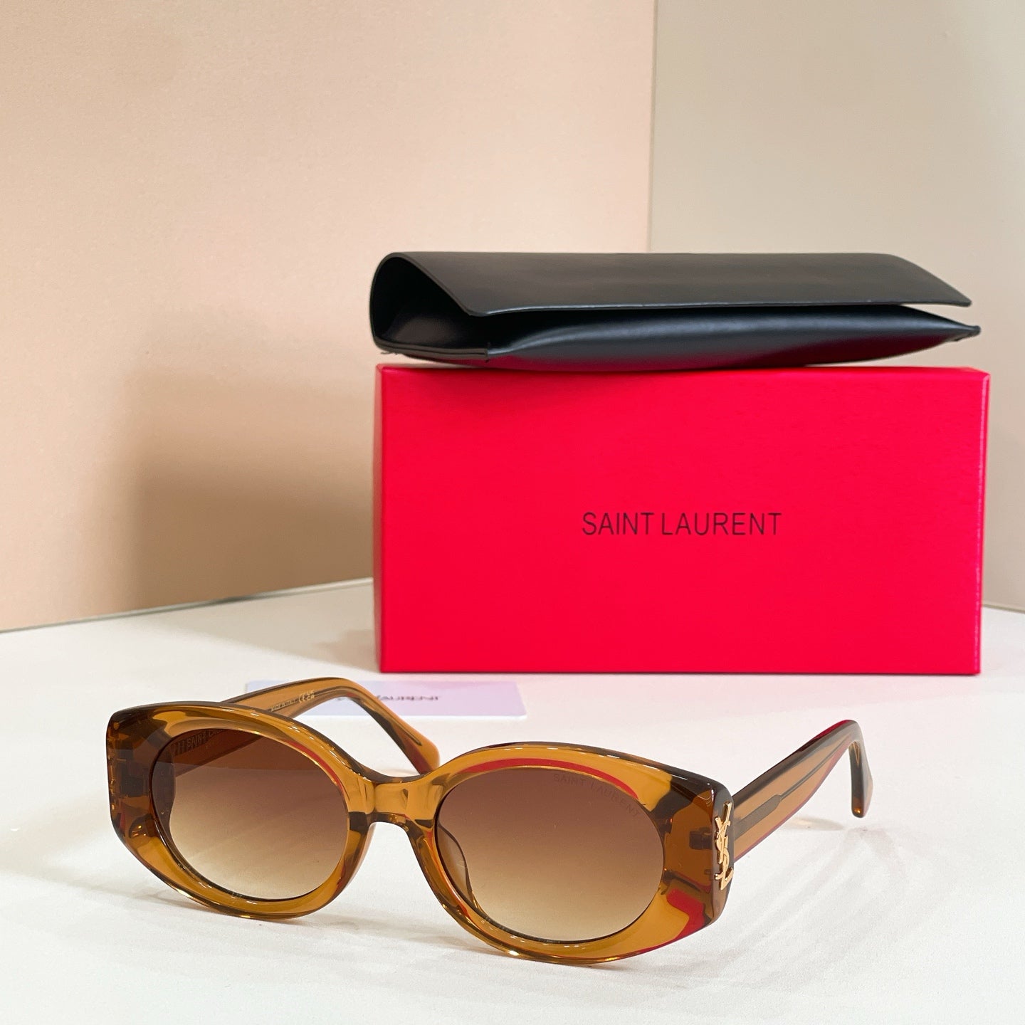 Amber round sunglasses with warm lenses and gold temple detail
