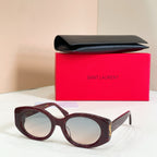 Burgundy round eyeglasses with clear lenses and gold temple detail
