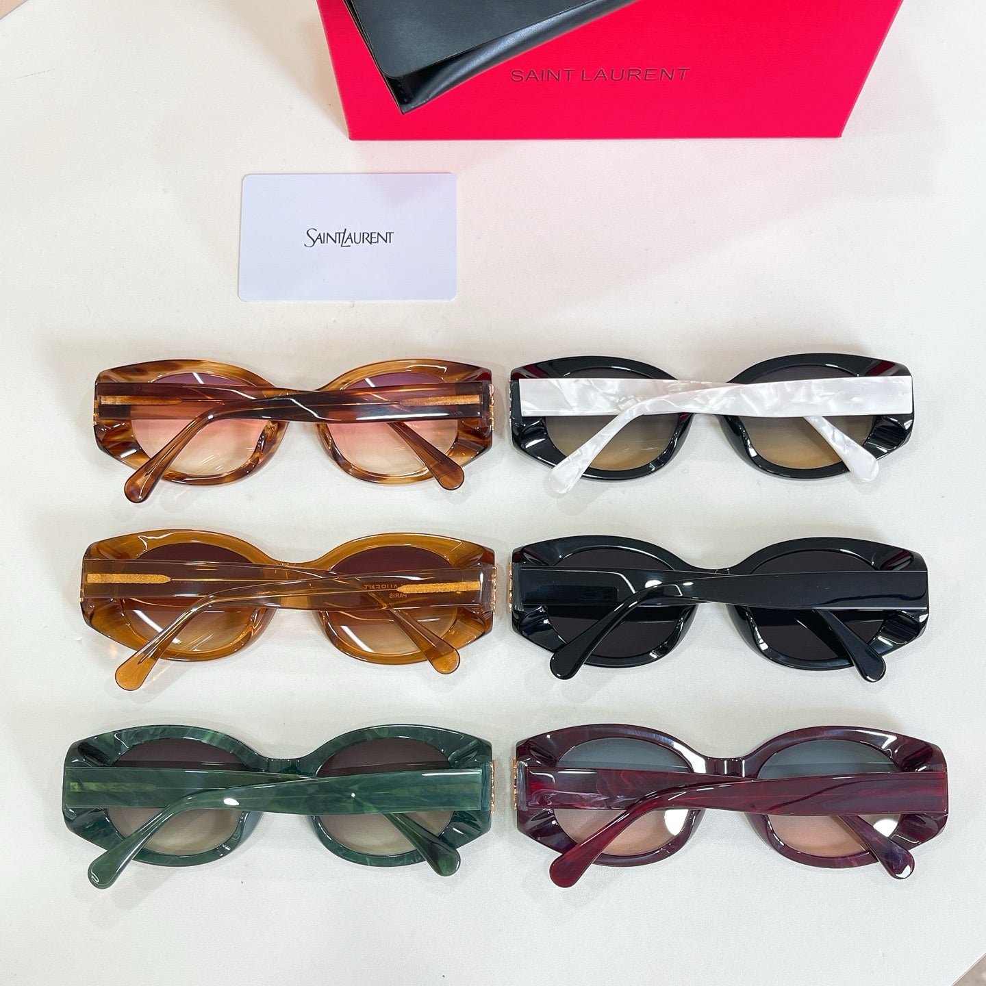 Assorted eyeglasses set with tortoiseshell, black, green, and burgundy round frames and card