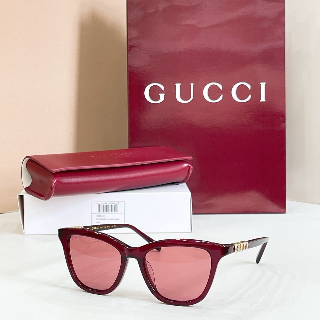 Gucci sunglasses, burgundy frame with pink tinted lenses and gold-tone bridge detail