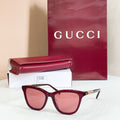 Gucci sunglasses, burgundy frame with pink tinted lenses and gold-tone bridge detail