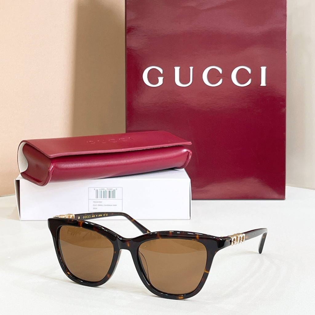 Gucci sunglasses, tortoiseshell frame with amber tinted lenses and gold-tone tips