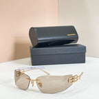 Gold-frame sunglasses with light gray tinted lenses and Balenciaga B logo temple detail