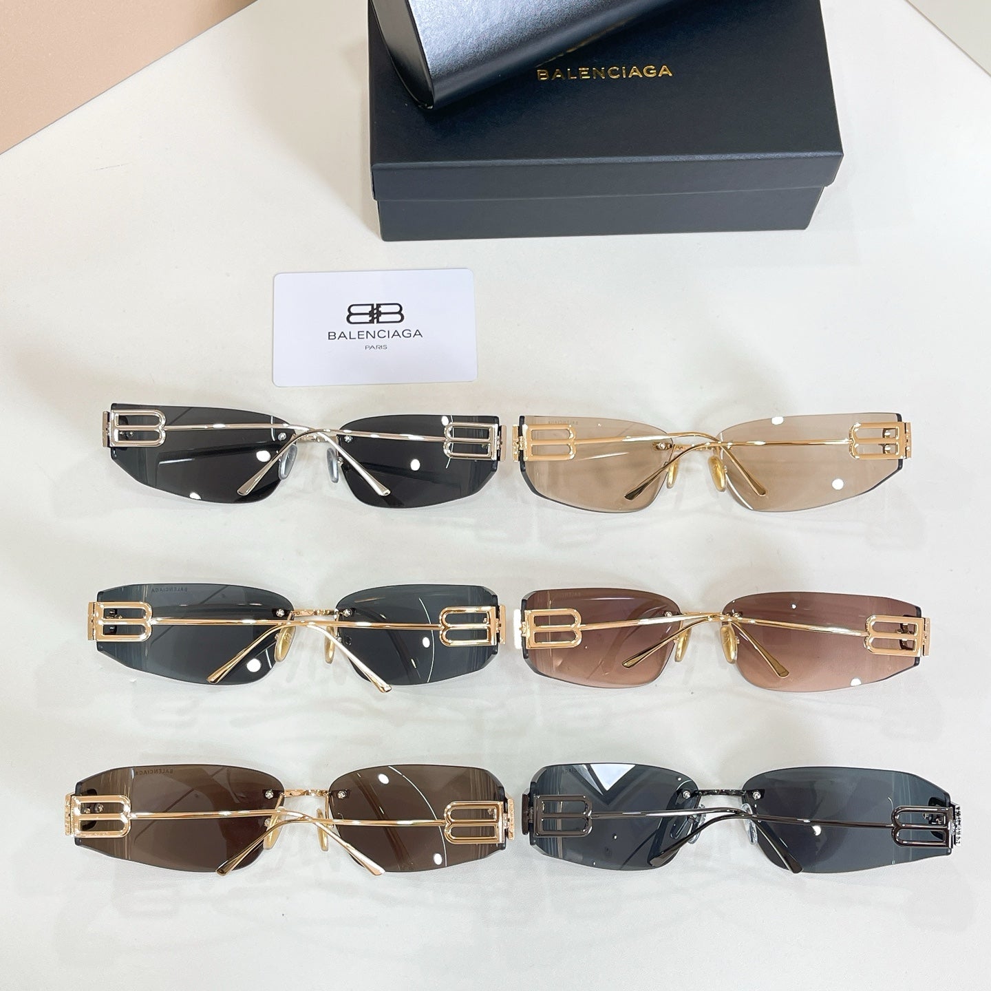 Assorted Balenciaga sunglasses set with gold frames and dark tinted lenses, multiple styles