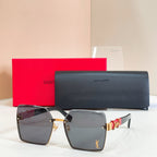 YSL glasses, gray-tinted lenses with dark frames and gold side logo detail