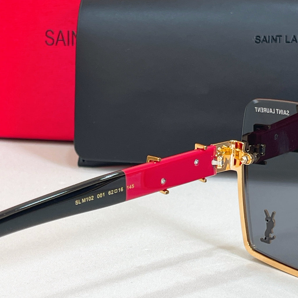 Glasses arm detail with red acetate and gold logo hardware