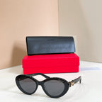 YSL glasses, black cat-eye frames with tinted lenses