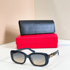 Navy blue rectangular eyeglasses with clear lenses and gold logo detail on temples