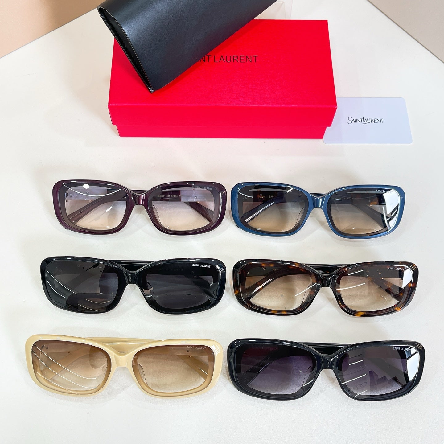 Assorted rectangular eyeglasses with tinted lenses in black, blue, tan, and tortoiseshell