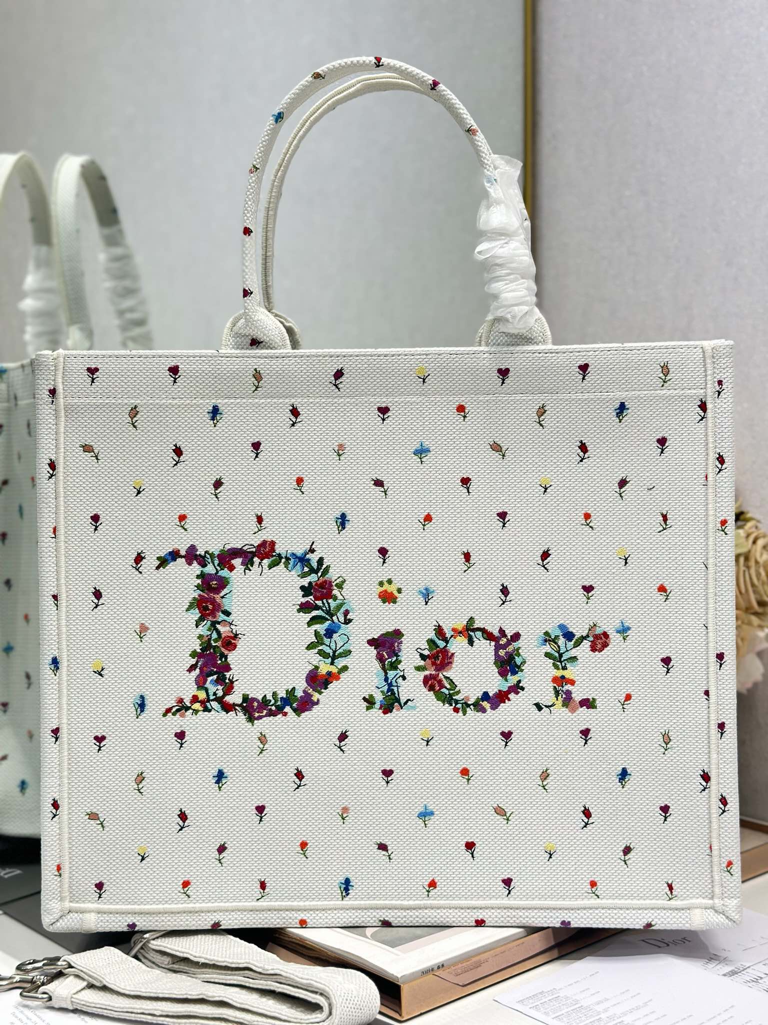 White Dior tote bag front with multicolor embroidered floral letter design