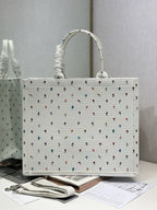 White Dior tote bag with ruched handle and allover multicolor motif