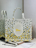 Dior tote bag in white fabric with yellow floral and cactus print, oval Dior logo front.