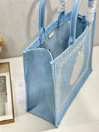 Light blue Dior tote bag, open side view with structured sides and interior