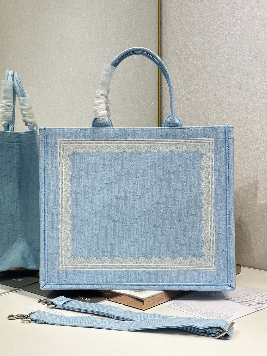 Light blue Dior tote bag with large front panel and top handles