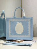 Light blue Dior tote bag with embroidered oval Dior logo patch and top handles