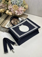 Navy Dior tote bag with top handle, front logo panel, and matching strap pieces