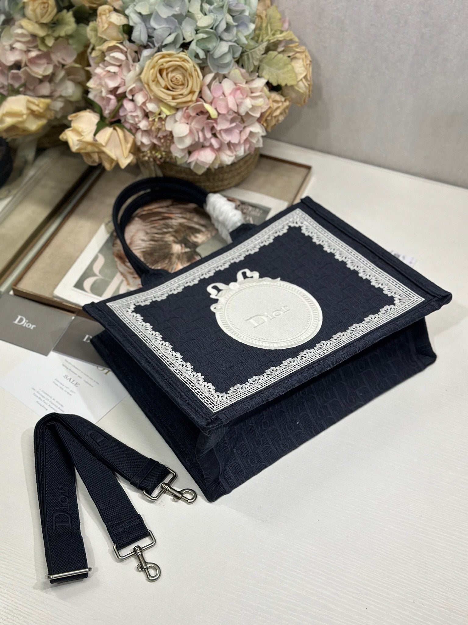 Navy Dior tote bag with top handle, front logo panel, and matching strap pieces