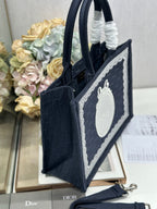 Navy Dior tote bag shown from the side with front logo panel and structured base