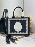 Navy Dior tote bag with top handles and white logo medallion on front panel