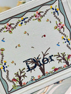 Dior tote bag embroidered panel close-up with colorful floral and tree motifs