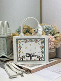 Dior tote bag in light gray canvas with embroidered floral panel and top handles