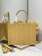 Dior gold handbag with top handles, quilted texture, and Dior charm on front.