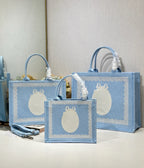 Light blue Dior tote bags with oval white logo and braided handle tassels